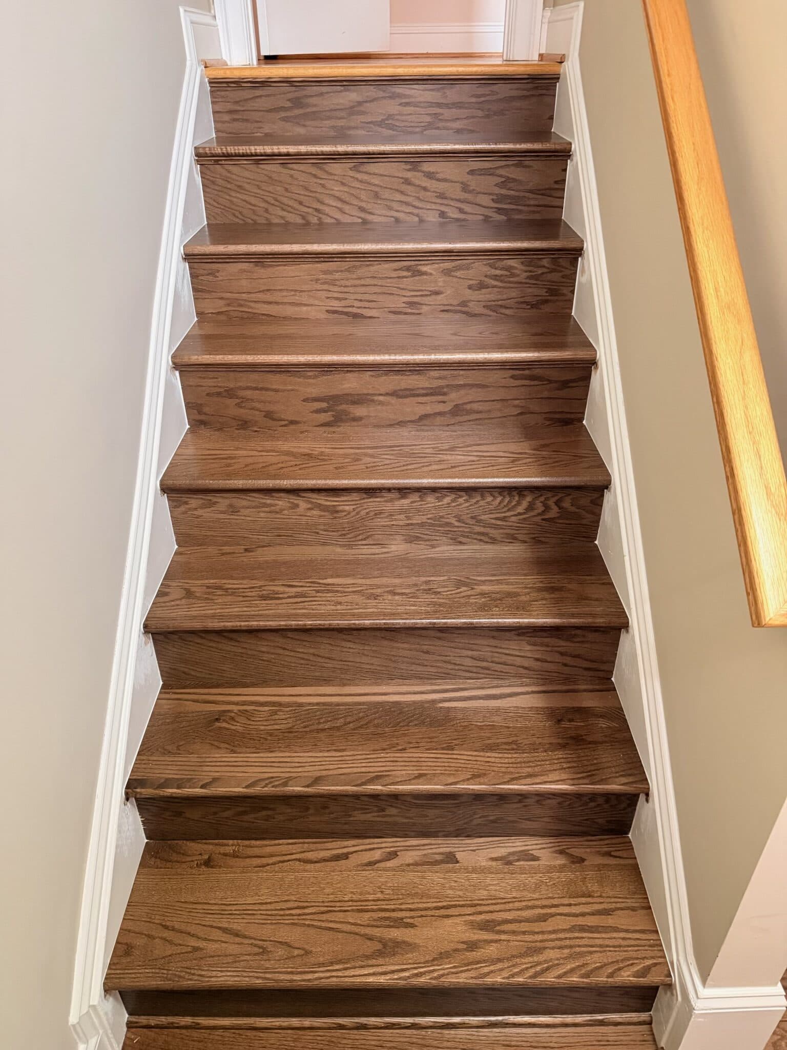 The finished flight from the bottom, hardwood treads and risers between white skirt boards