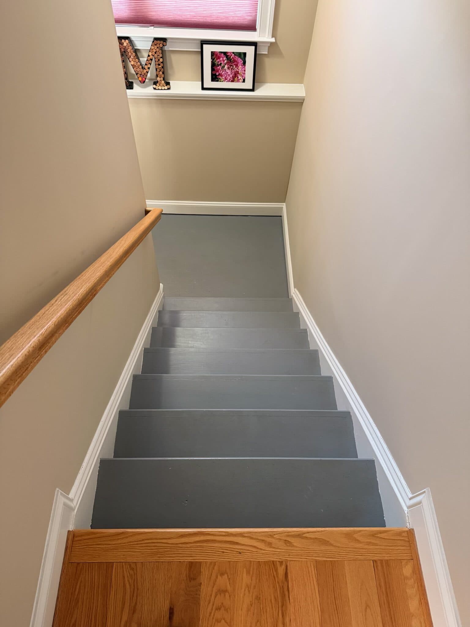 Before: a staircase with grey-painted treads and risers, looking down the flight